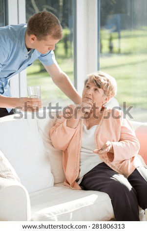 Male nurse caring for an elderly patient