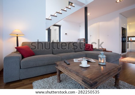 Photo of old fashion coffee table in front of grey comfortable sofa