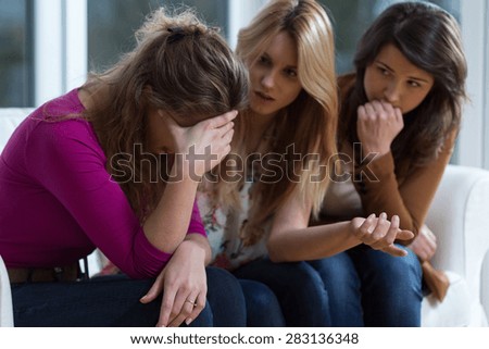 Sad girl and supporting friends trying to solve a problem