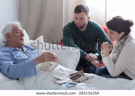 Older sick man in hospital opening old letters