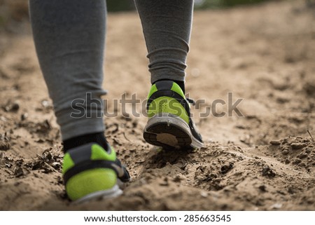 Close-up of woman runner\'s legs jogging outdoors