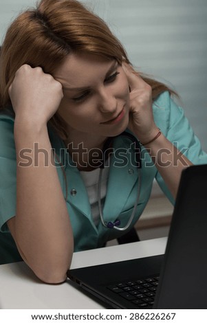 Medical student is working on her laptop