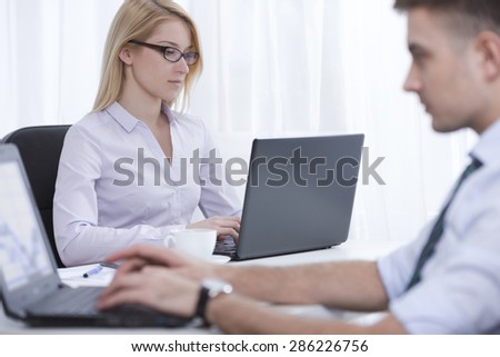 Photo of two employees working in corporation