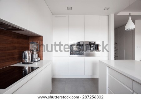 Elegant cozy kitchen with white units and marble floor