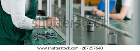 Close-up of older working at factory woman\'s hands