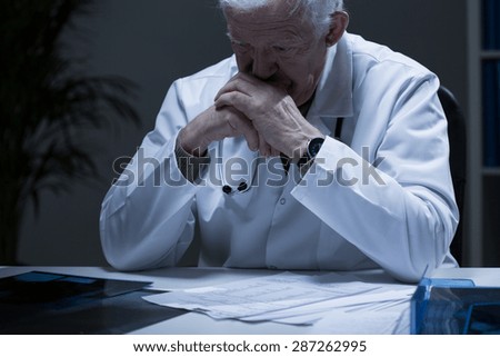 Old doctor with deep depression crying in solitude