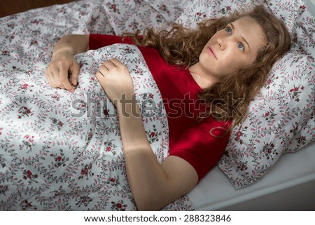 Young woman cannot sleep because of the nightmare