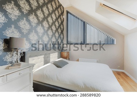 Black oriental wallpaper in small bright bedroom