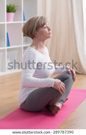 Middle aged lady and her breathing exercises in yoga
