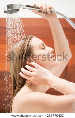 Woman wash her hair in the bathtub
