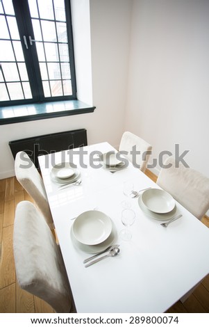 White small table with four table setting