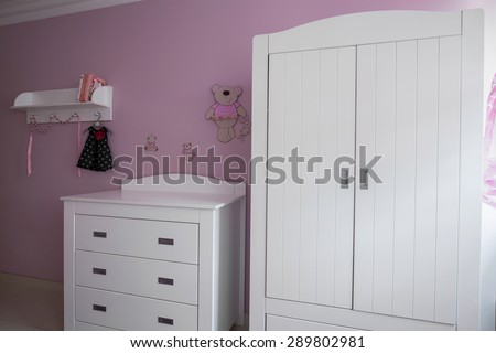 Interior of white and rose baby room