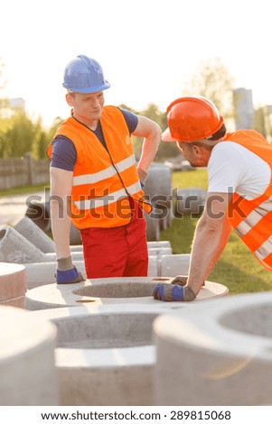 Tired construction workers having small talk at work