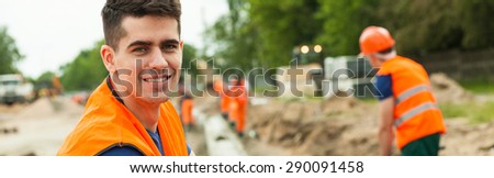 Construction worker is smiling because of his job
