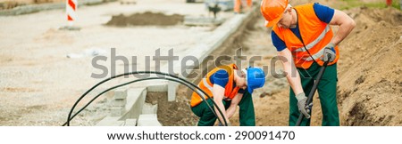 Construction workers are placing the electrical cables
