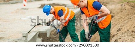Construction workers are digging a hole for the electrical cables