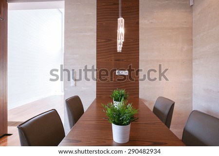 Big family table in dining hall with floral decorations