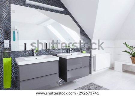 Modern white and grey bathroom in the attic