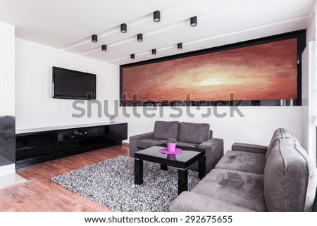 Big painting on the wall in elegant sitting room