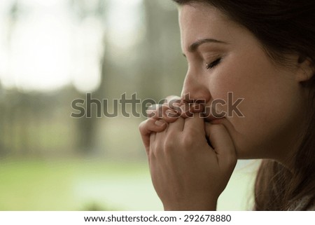 Horizontal view of depressed young woman crying