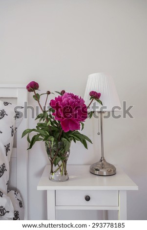 Peony in the vase on the nightstand