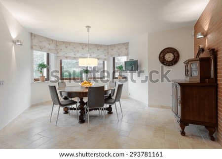 Wooden round table in cozy dining room