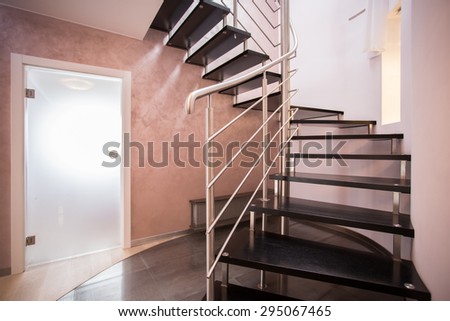 Wooden spiral stairs in luxury modern house