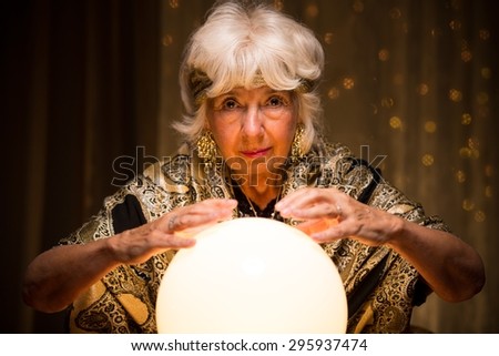 Image of elder mystique woman with magic crystal ball