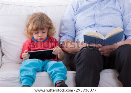 Little smart boy learning how to use tablet