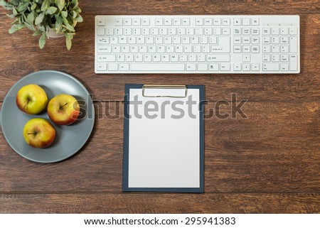Photo of well organized wooden desk with healthy snacks