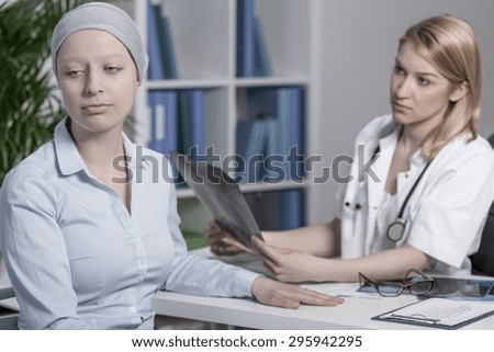 Young doctor with bad news for her cancer patient