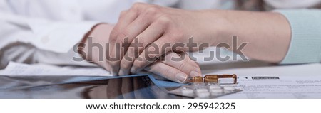 Panoramic photo of two women\'s hands holding each other