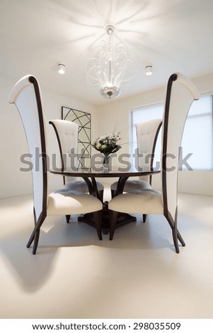 Wooden round table in exclusive dining room