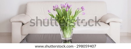Vase with violet flowers on the table