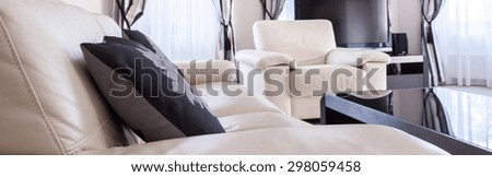 Close-up of cream sofa with black cushions