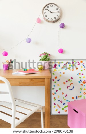 Colorful children study room with wooden desk and magnetic board