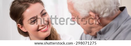 Young woman smiling to elder man
