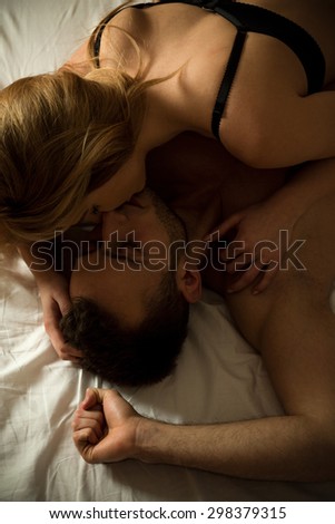 Young marriage having intimate moments in bedroom