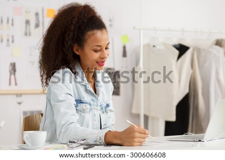 Image of young woman designer working with passion
