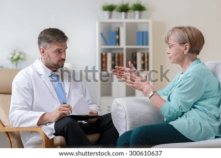 Image of psychiatrist listening to his female patient with depression