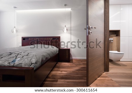 Bedroom connected with bathroom in wooden house