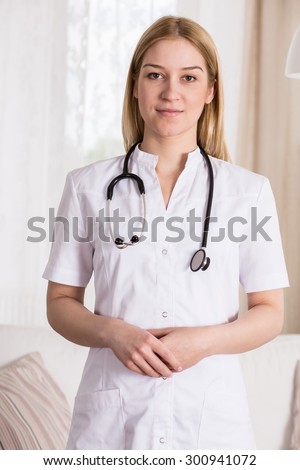 Young beauty female doctor in white apron