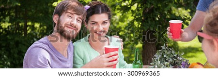Panorama of smiling couple enjoying holidays during barbecue
