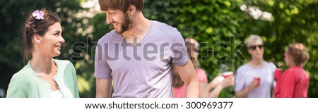 Panorama of man and woman hanging out during summer barbecue
