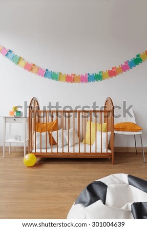 Photo of contemporary design spacious baby room with simple bed