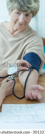 Older person is having blood pressure checked