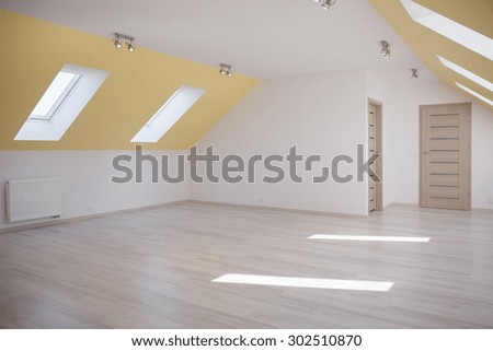 Huge empty bright room in the loft of commodious house