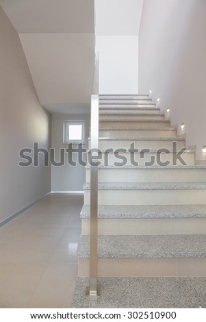 Marble stairs with steel handrail in minimalist storey house