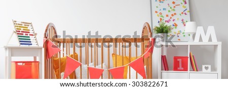 Wooden crib in beautiful baby nursery - panorama