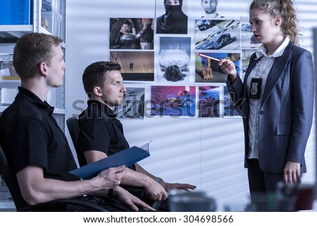 Photo of female police officer and her male partners